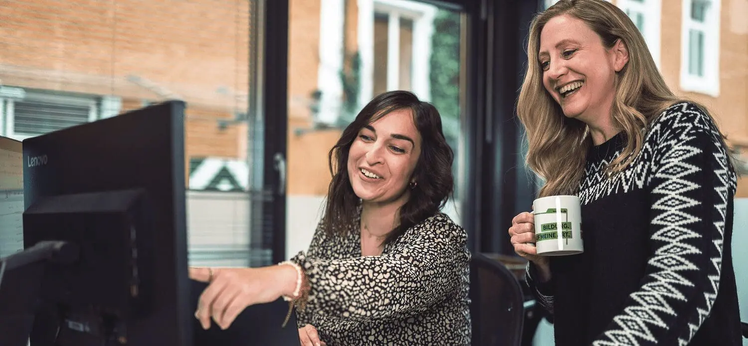 Two colleagues checking screen