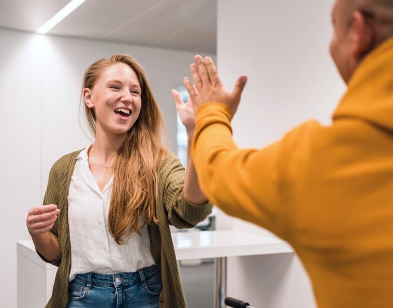 High-five between to happy students