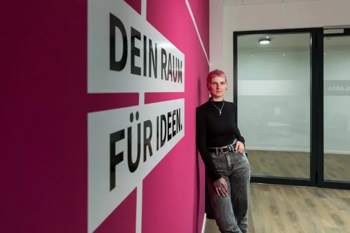 woman infront of pink wall