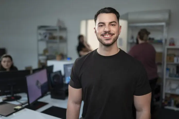 Man smiling camera Tech office